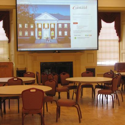 Formal room with projection screen and round tables