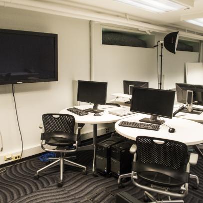 round tables in lab with display on wall