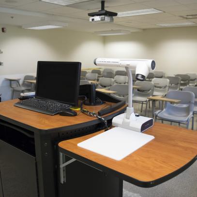 Lectern with monitor and doc cam with seating in the background