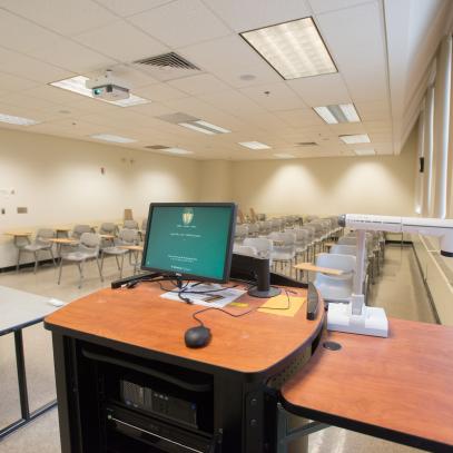 Lectern with monitor and seating in the background