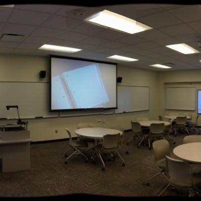Three displays with tables in middle of room