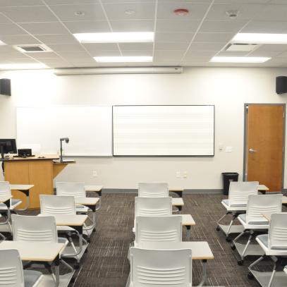Classroom with lectern and presentation on front wall